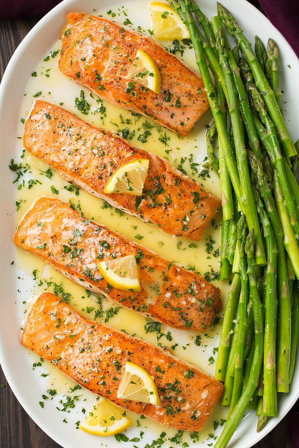 Overhead image of four cooked salmon fillets on a serving platter.