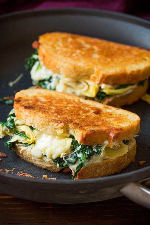 Two grilled cheese sandwiches in skillet. 