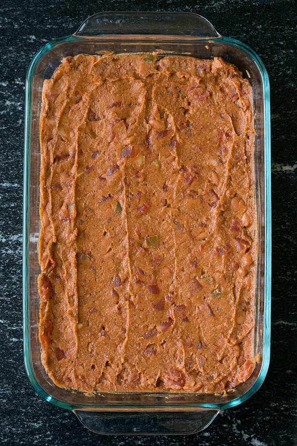 A GIF image showing layers of a 7-layer bean dip