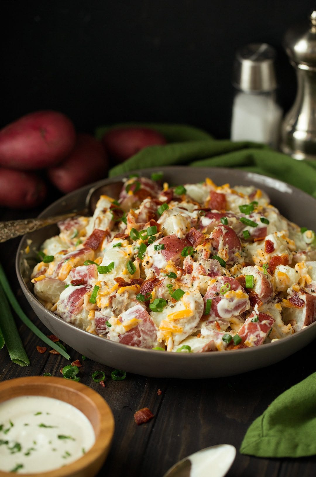 cheddar bacon ranch potato salad in a bowl with a spoon