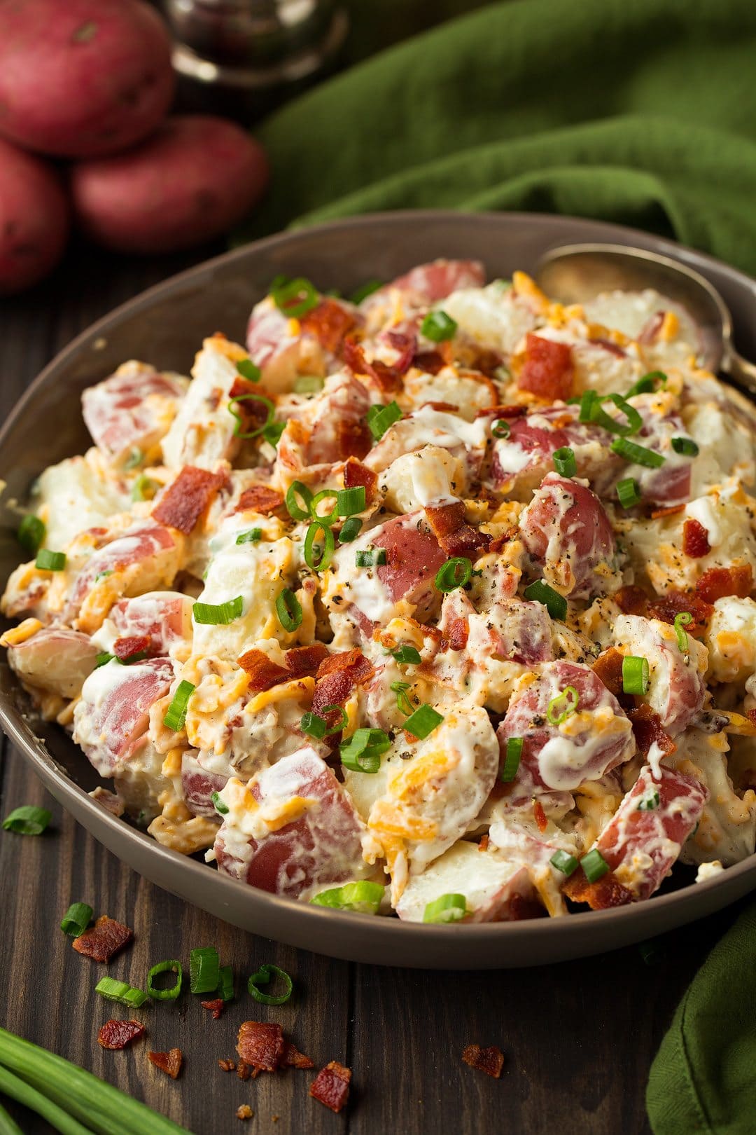 large bowl of cheddar bacon ranch potato salad with a spoon