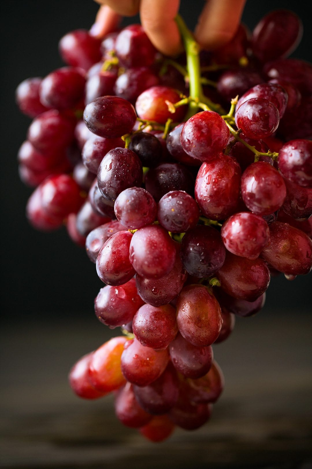Grape Salad Recipe Close up image of red grapes dripping with water.