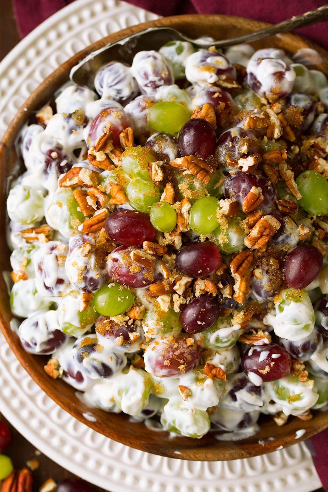 Overhead close up image of grape salad in a large wooden bowl.