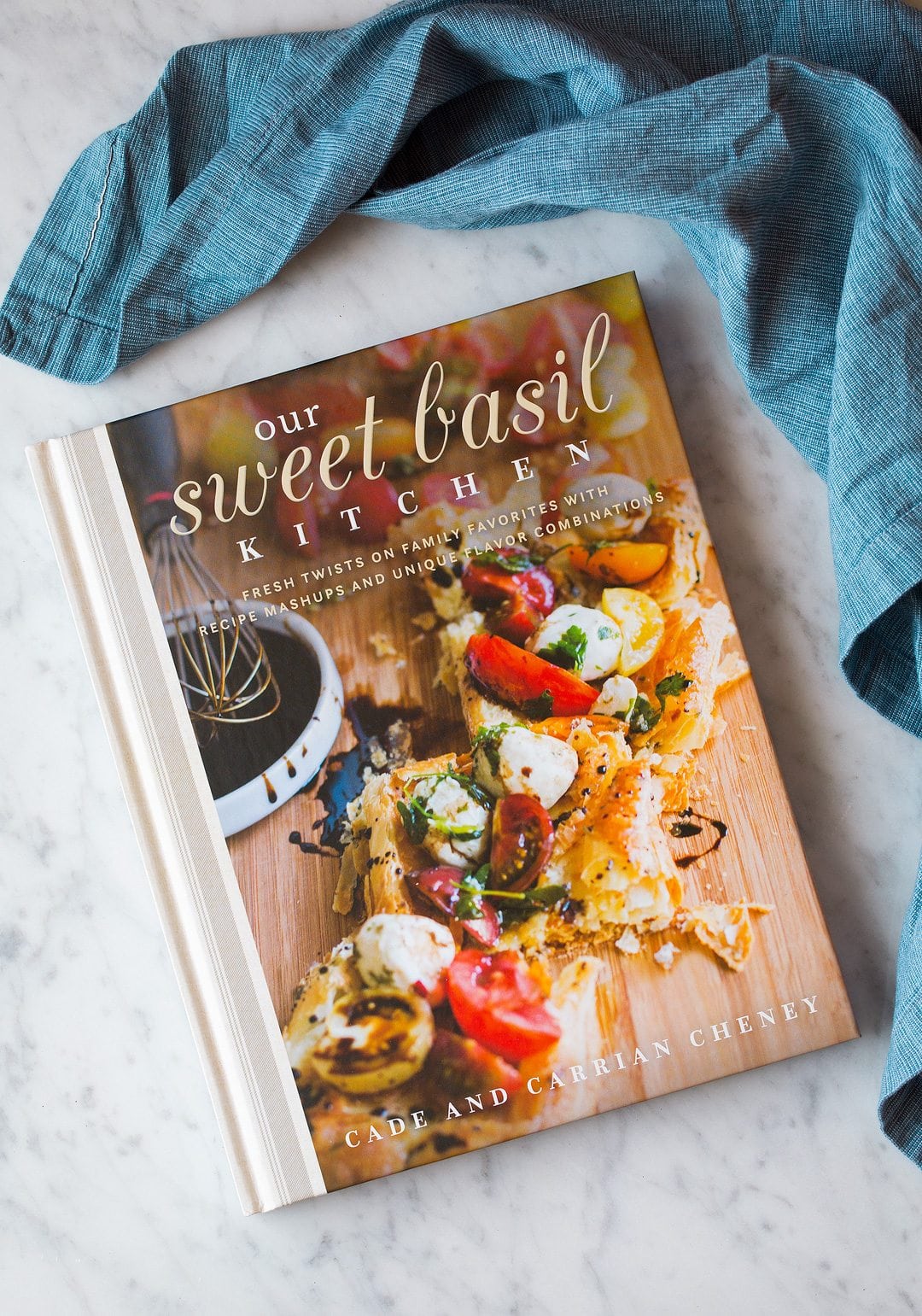 our sweet basil kitchen cookbook on counter with blue towel