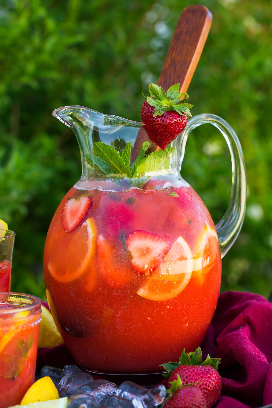 large pitcher of Strawberry Lemonade garnished with fresh strawberry