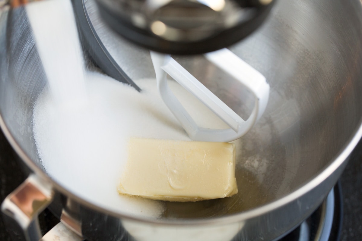 Showing how to make tres leches cake. Mixing butter and sugar in a stand mixer bowl.