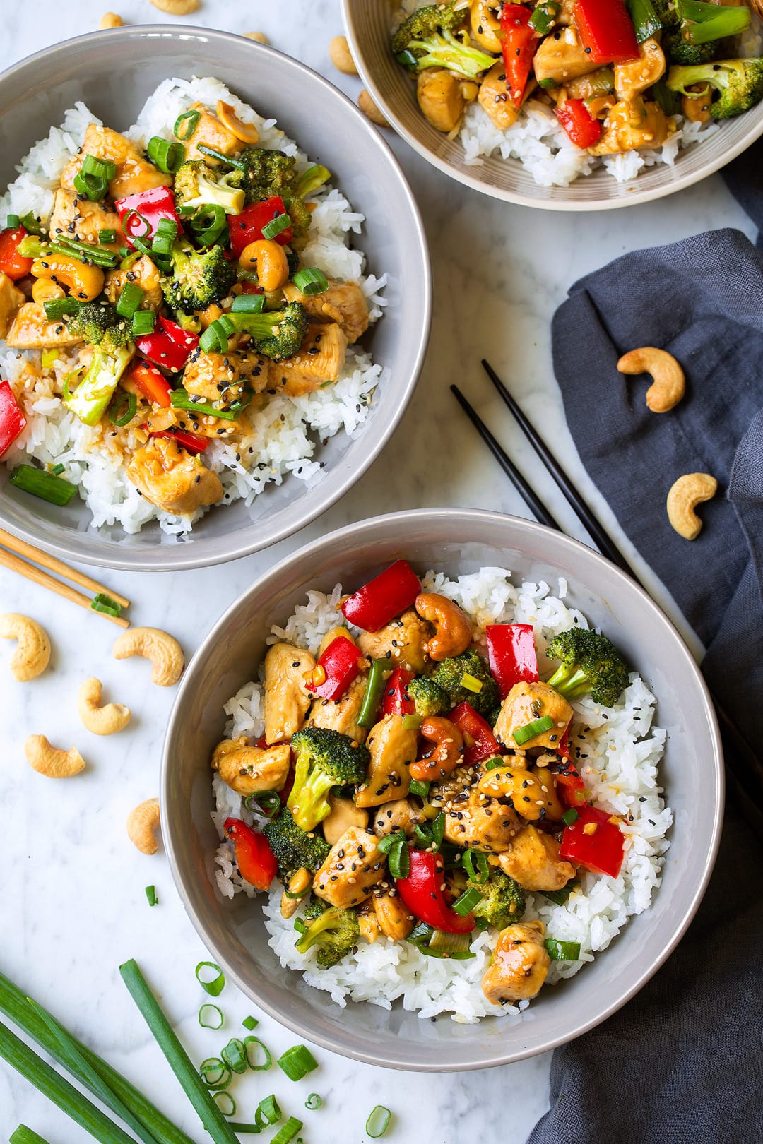Cashew Chicken in three bowls served over white rice.