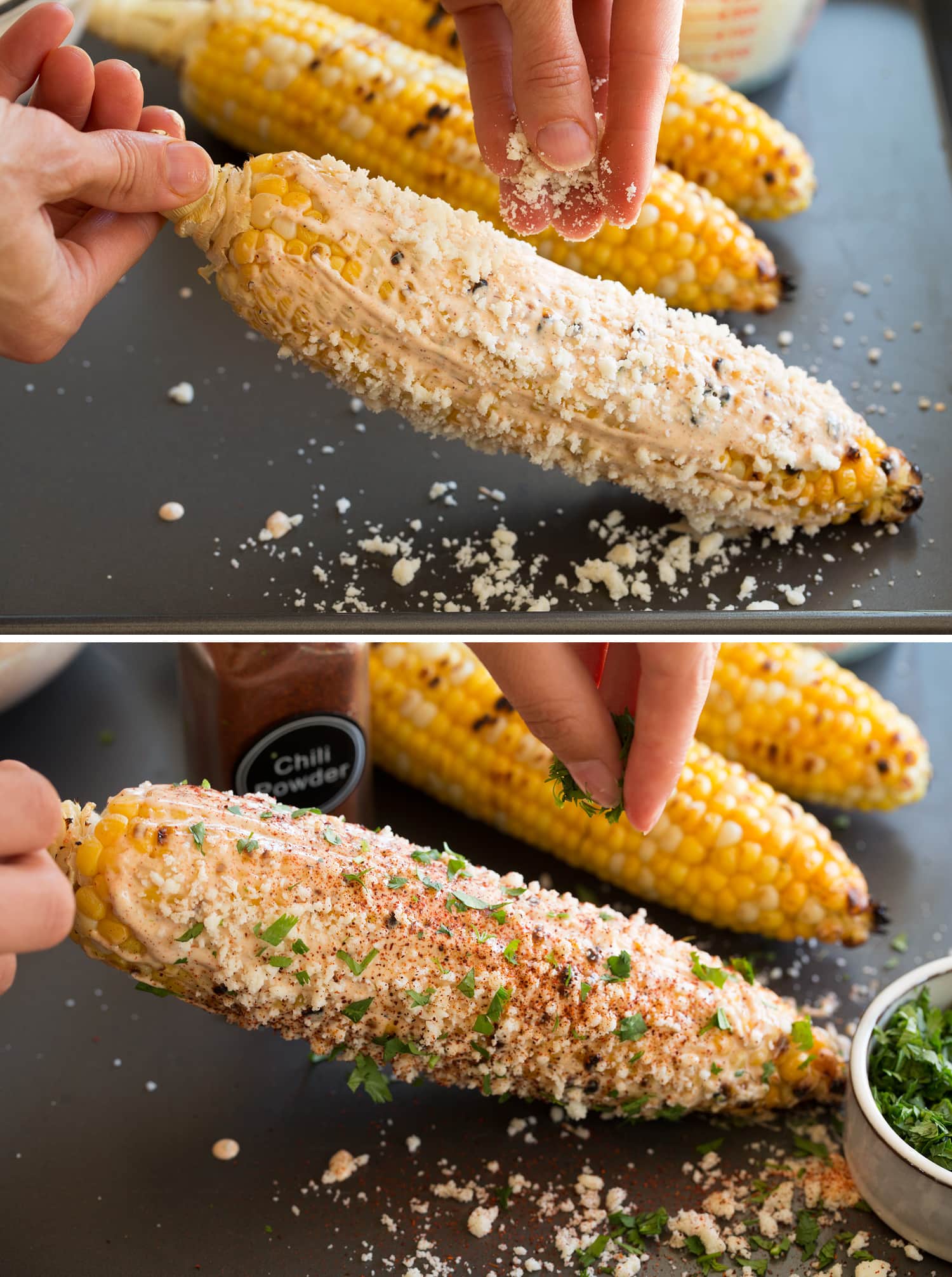 Adding cotija and chili powder to elotes.