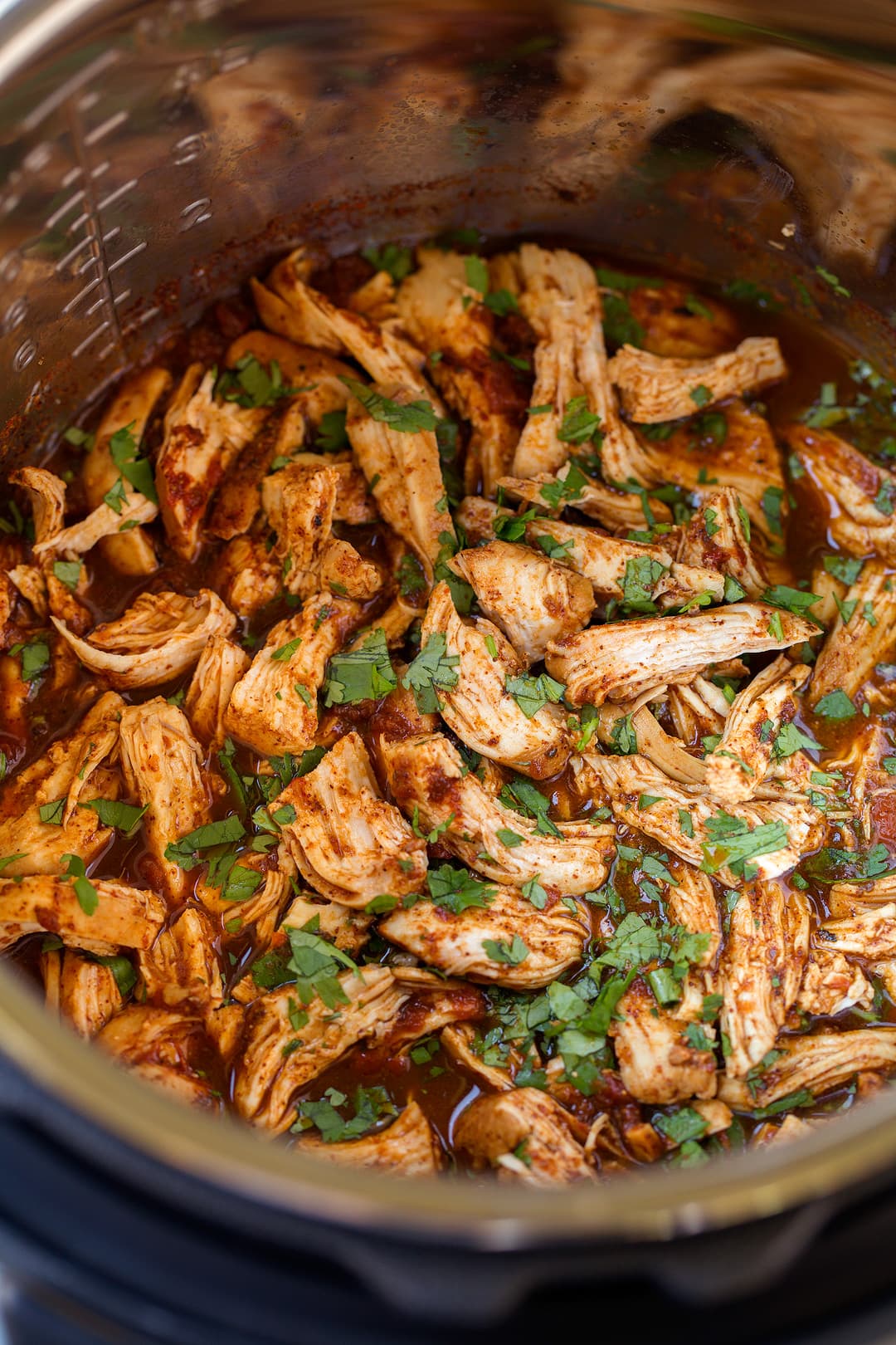 instant pot Salsa chicken after shredding garnished with cilantro.