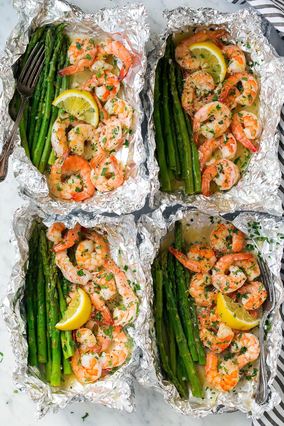 four Shrimp and Asparagus Foil Packs with Garlic Lemon Butter Sauce