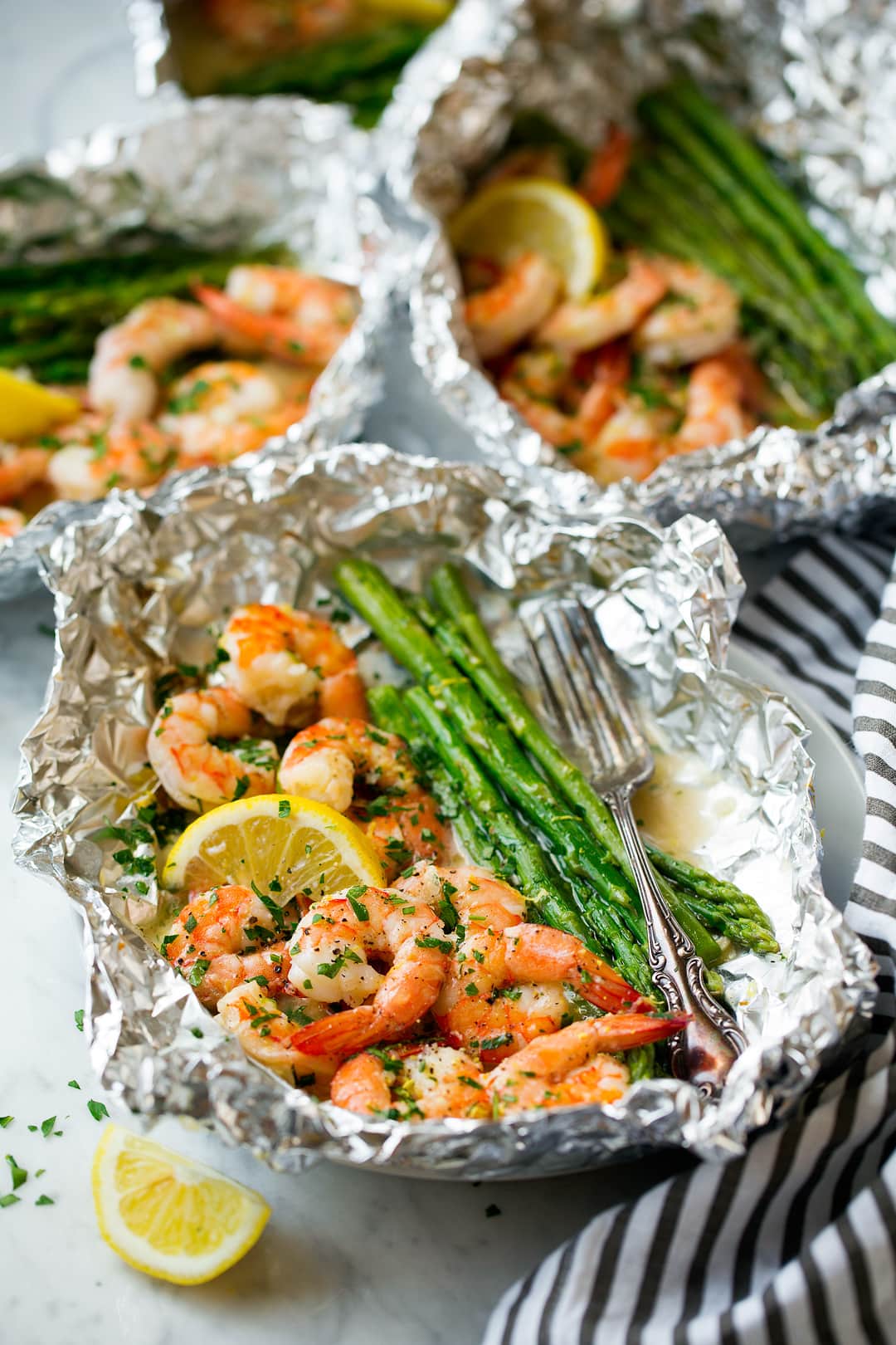 three asparagus and shrimp foil packets