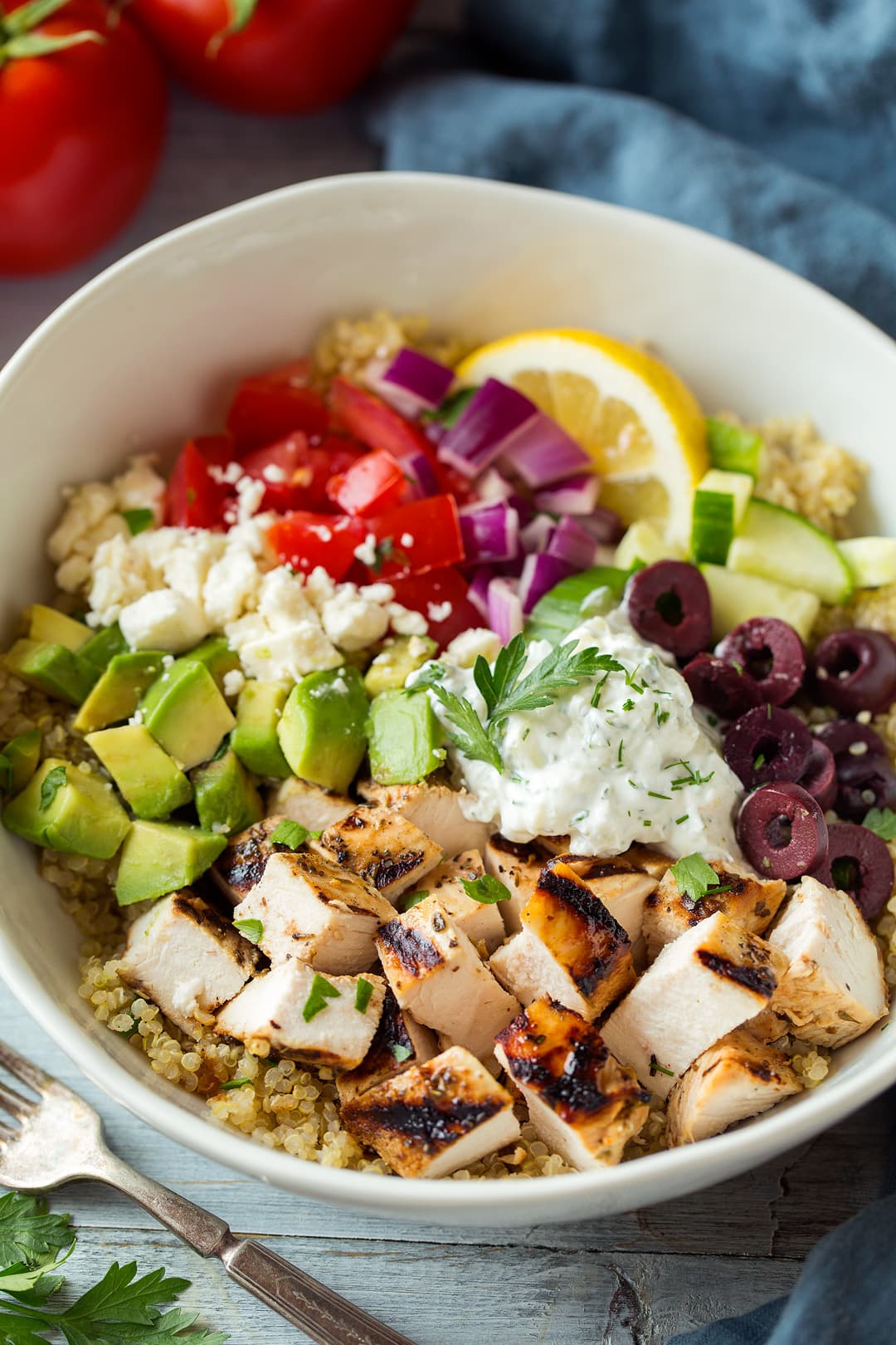 Grilled Greek Chicken Quinoa Bowl topped with tzatziki and avocado 