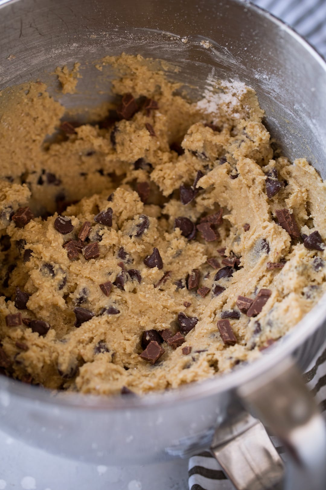 Chocolate chip cookie dough in mixing bowl.