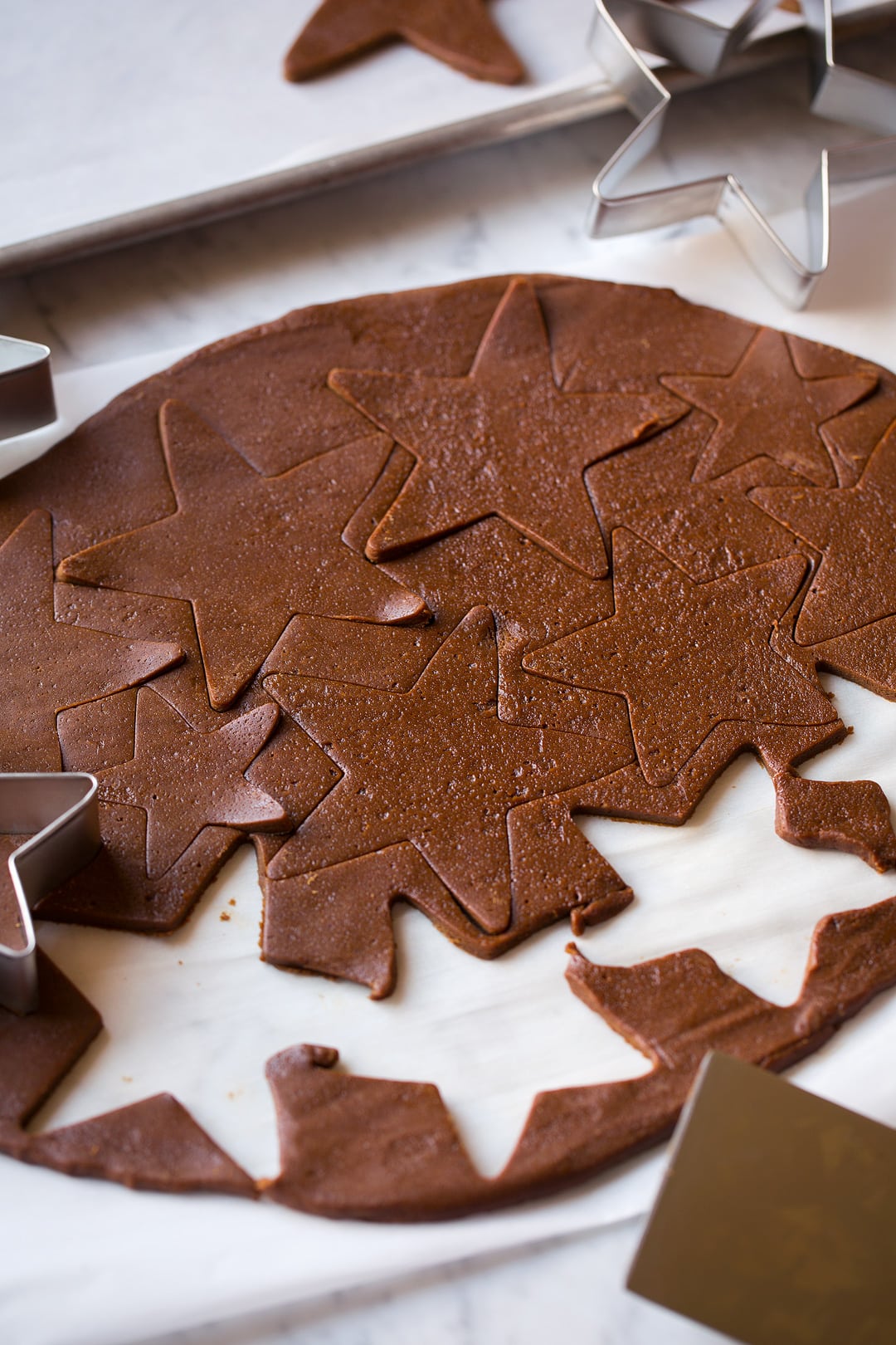 Gingerbread cookie dough cut into star shapes