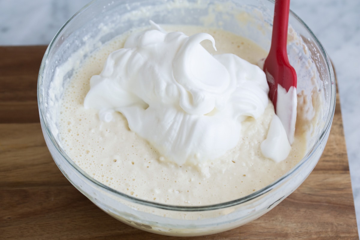 Folding egg whites into waffle batter.