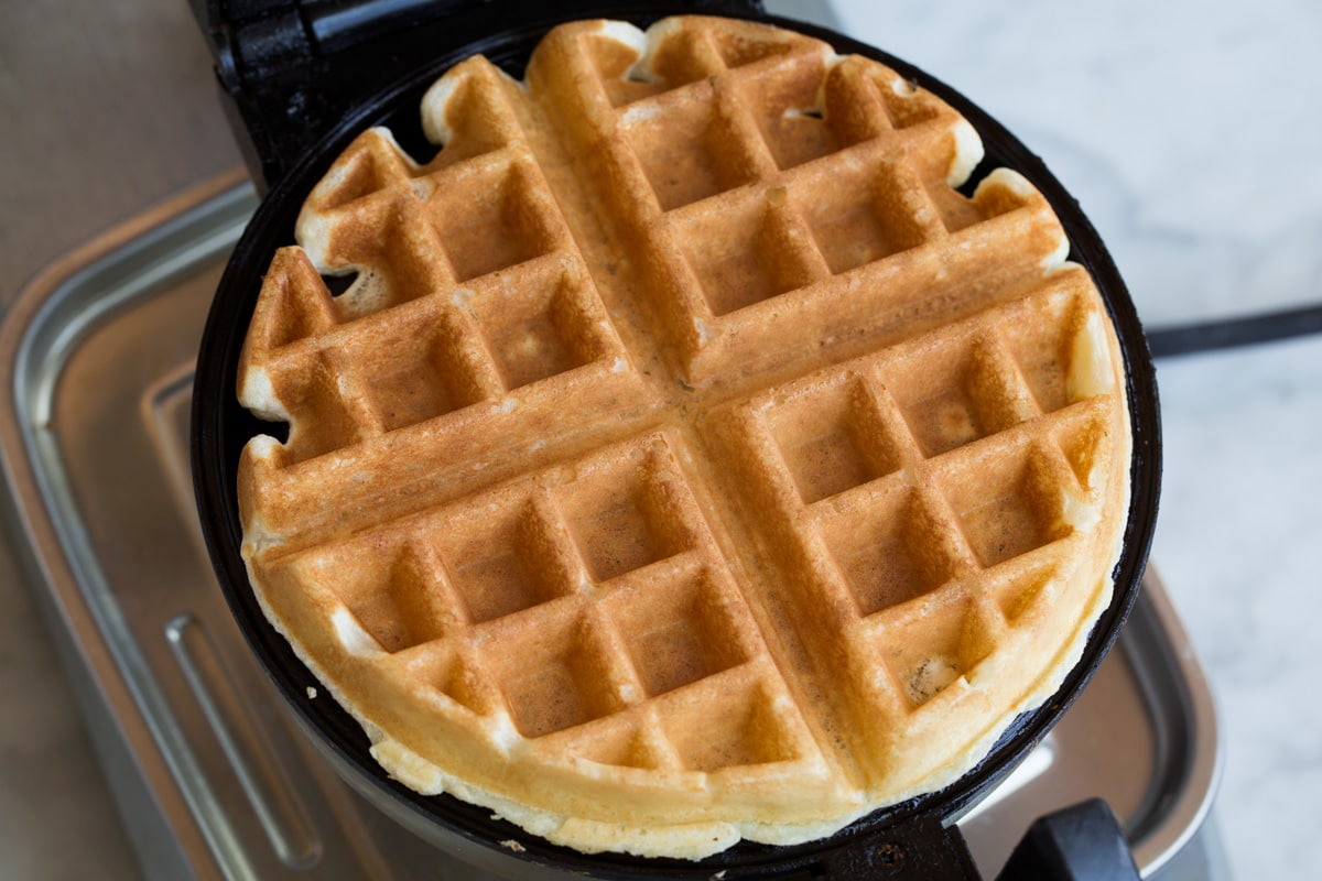 Belgian waffle after finished cooking on a waffle iron.