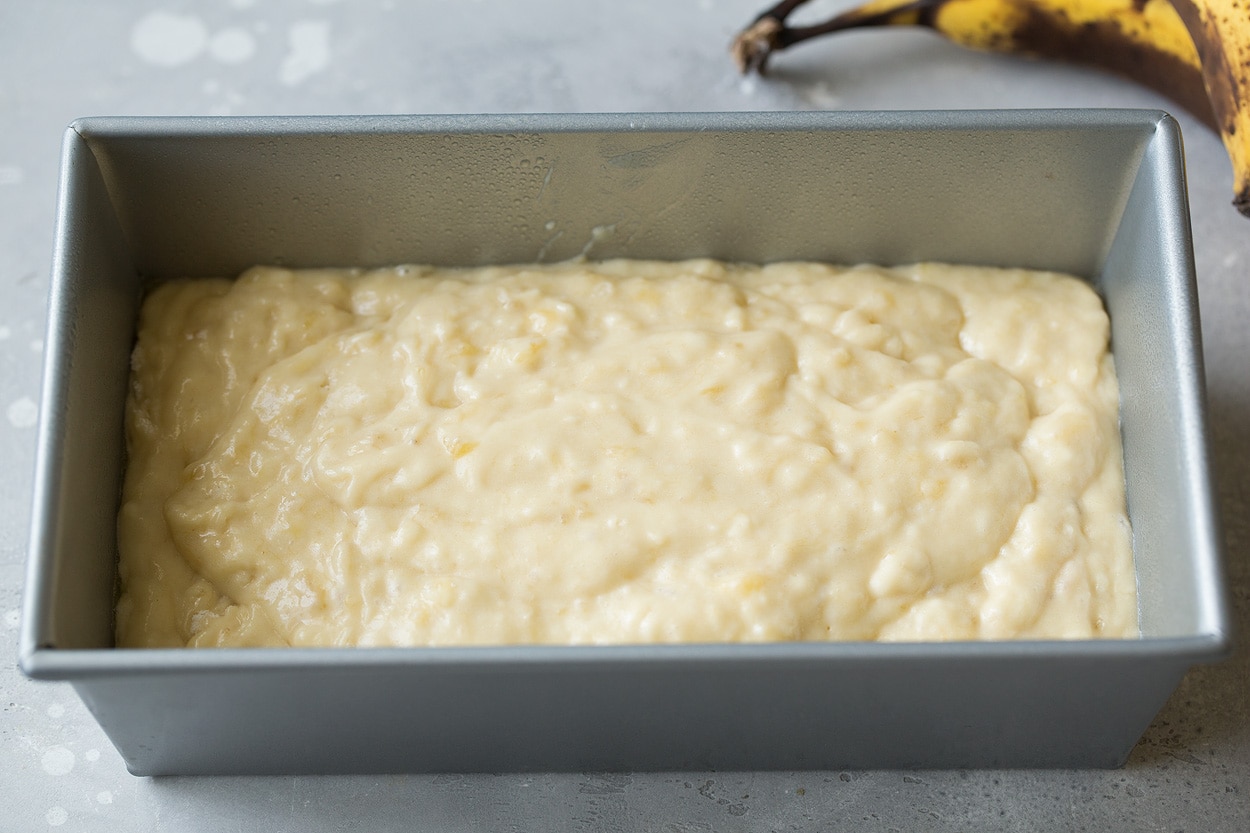 This is the best banana bread recipe! Quick and easy to make and no mixer is required. It's perfectly moist and amazingly tender and it's brimming with banana flavor. Simply put, everyone will have a hard time stopping at just one slice! #cookingclassy #banana #bread #bananabread banana bread mixture poured into loaf pan