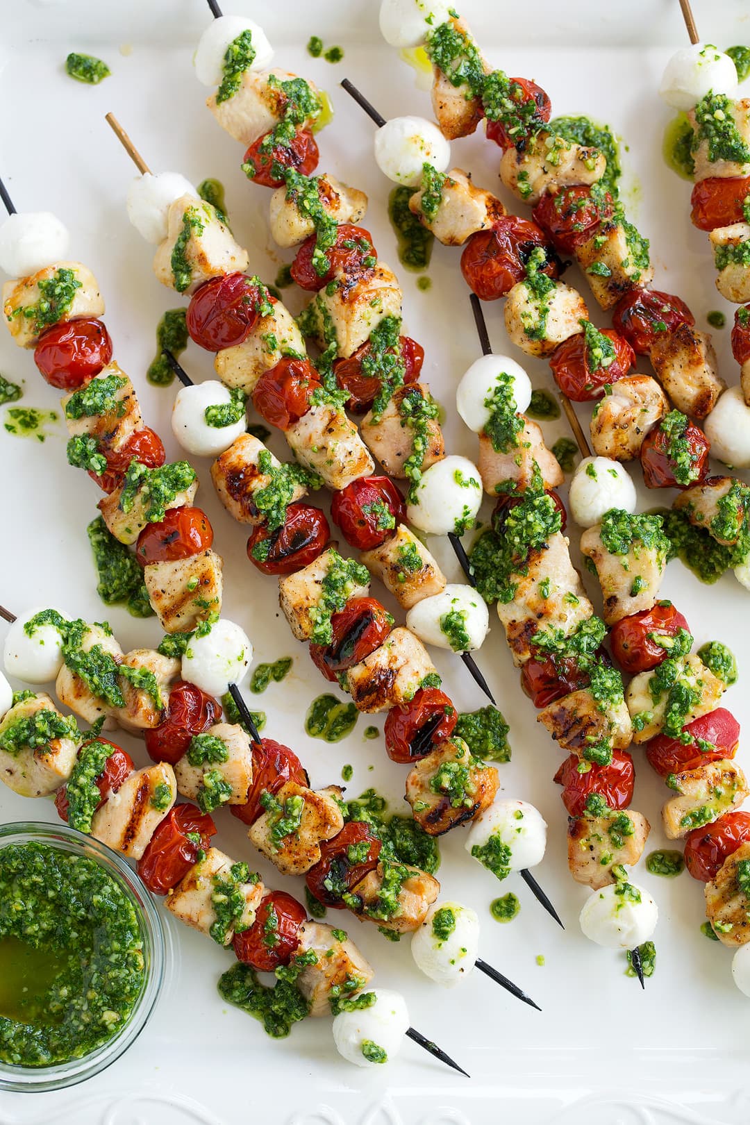Chicken Caprese Skewers drizzled with homemade pesto