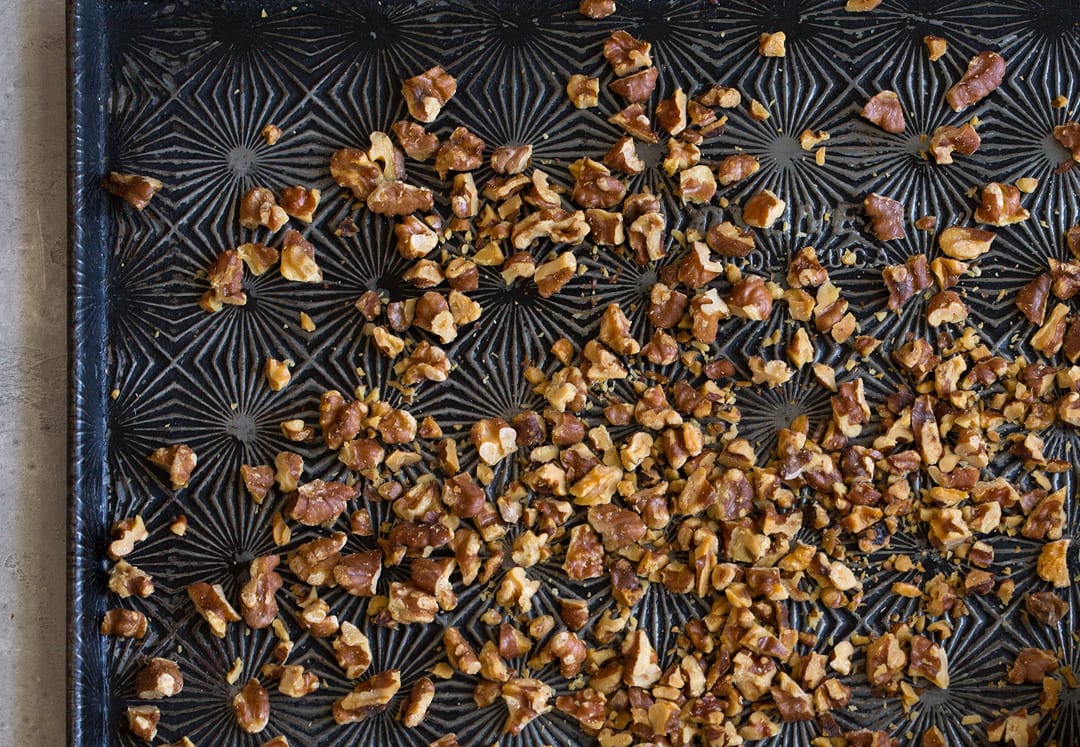 toasted walnuts on baking sheet