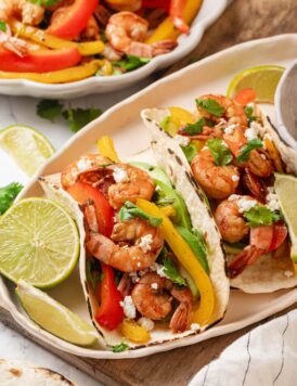Shrimp fajitas with peppers, avocado, queso fresco and lime.