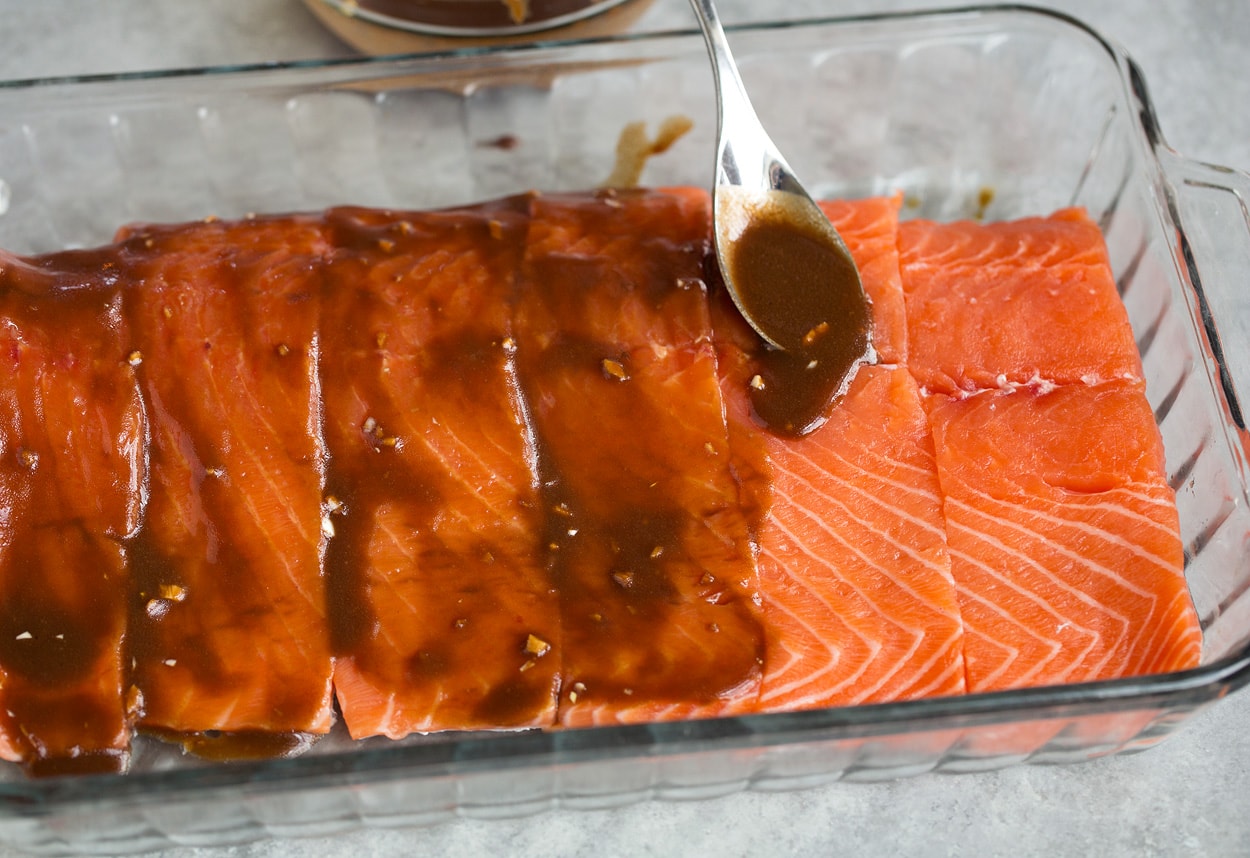spooning marinade over salmon for grilled salmon