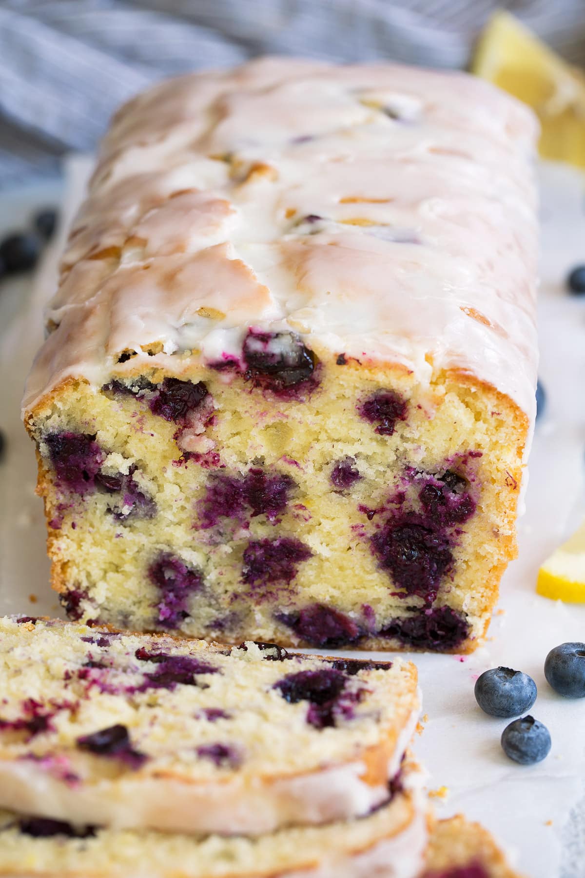 Lemon Blueberry Bread sliced and topped with lemon glaze icing