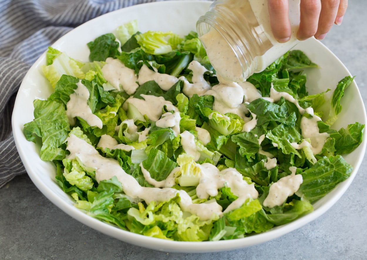 Adding dressing for Caesar Salad