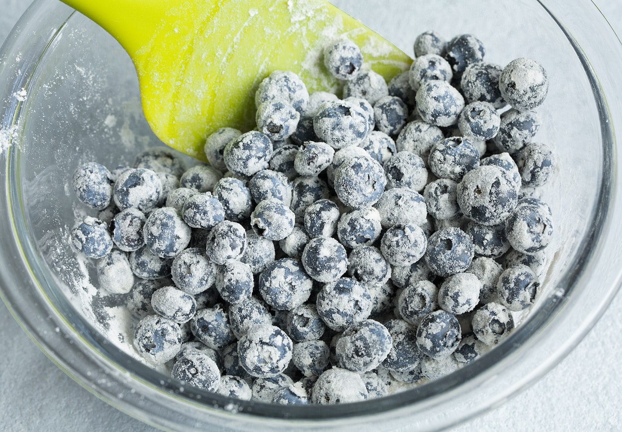 Lemon Blueberry Bread tossing blueberries with flour