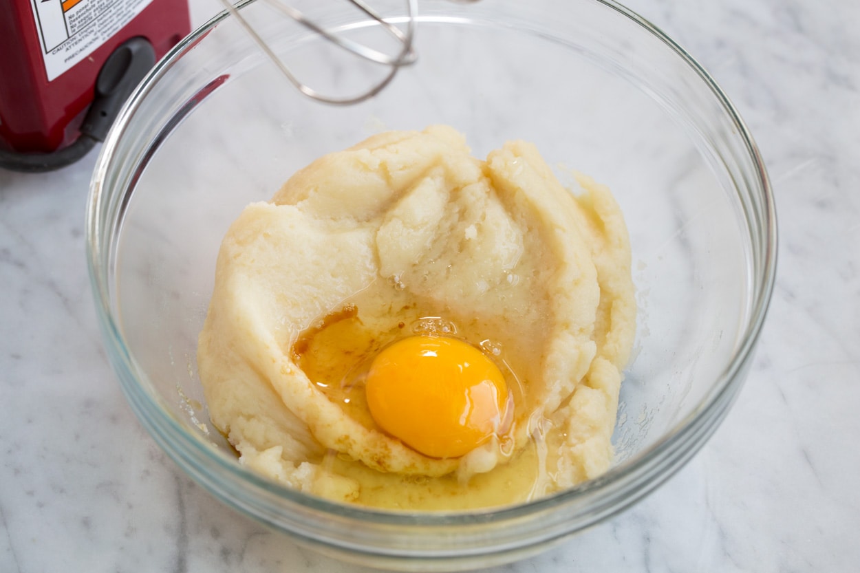 churros adding egg and vanilla to batter