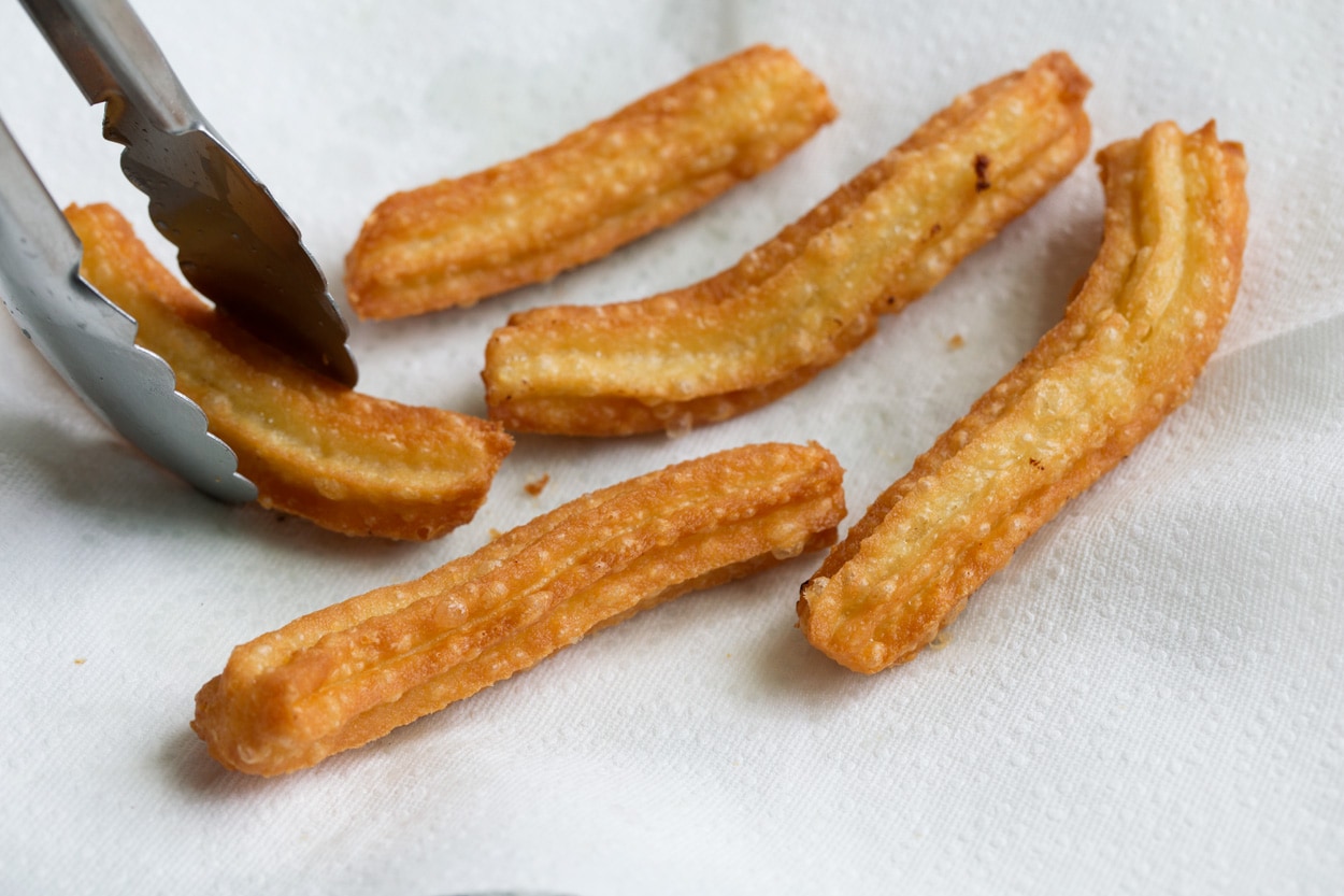 churros drying on paper towels