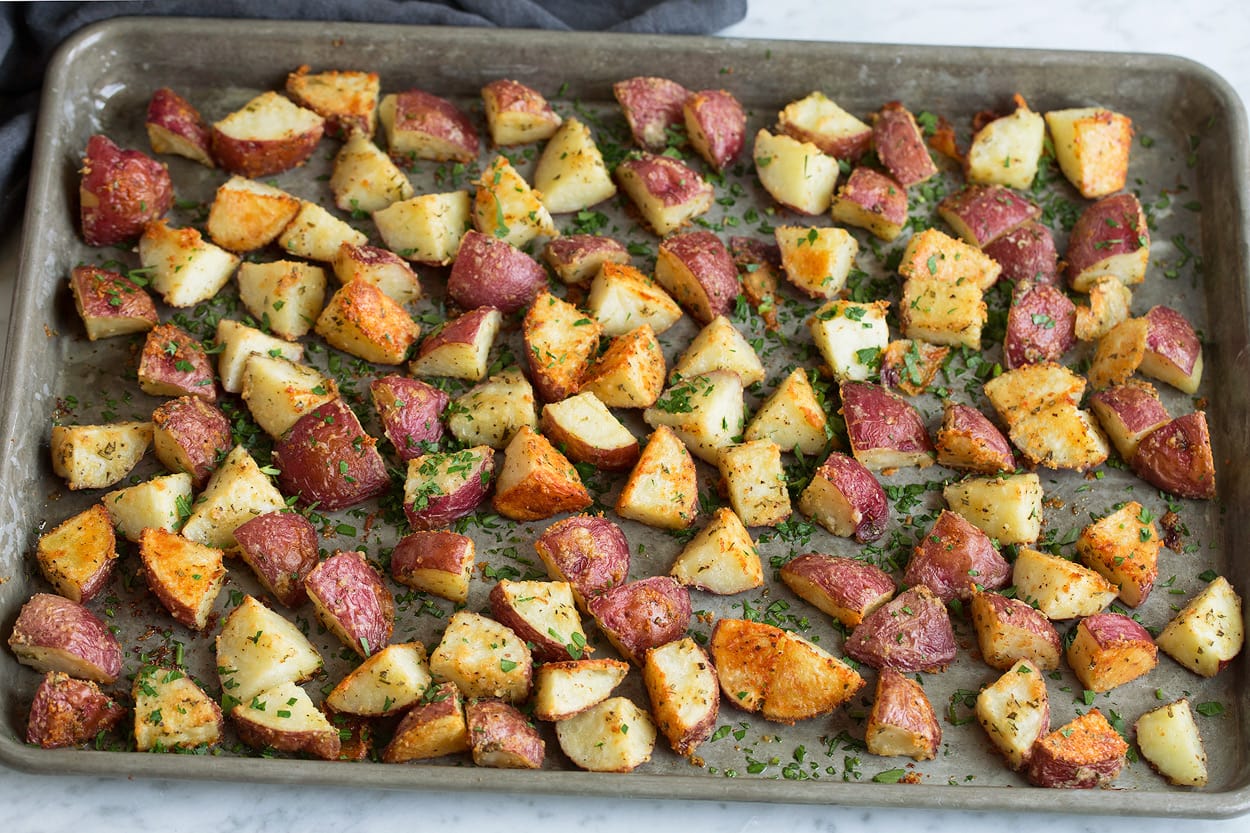 parmesan roasted potatoes on baking dish after roasting in oven showing their golden brown color.