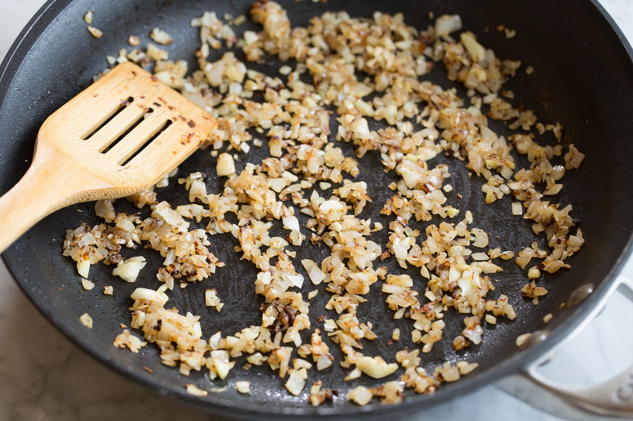 Sauteing onion and garlic in dark skillet for easy spaghetti sauce