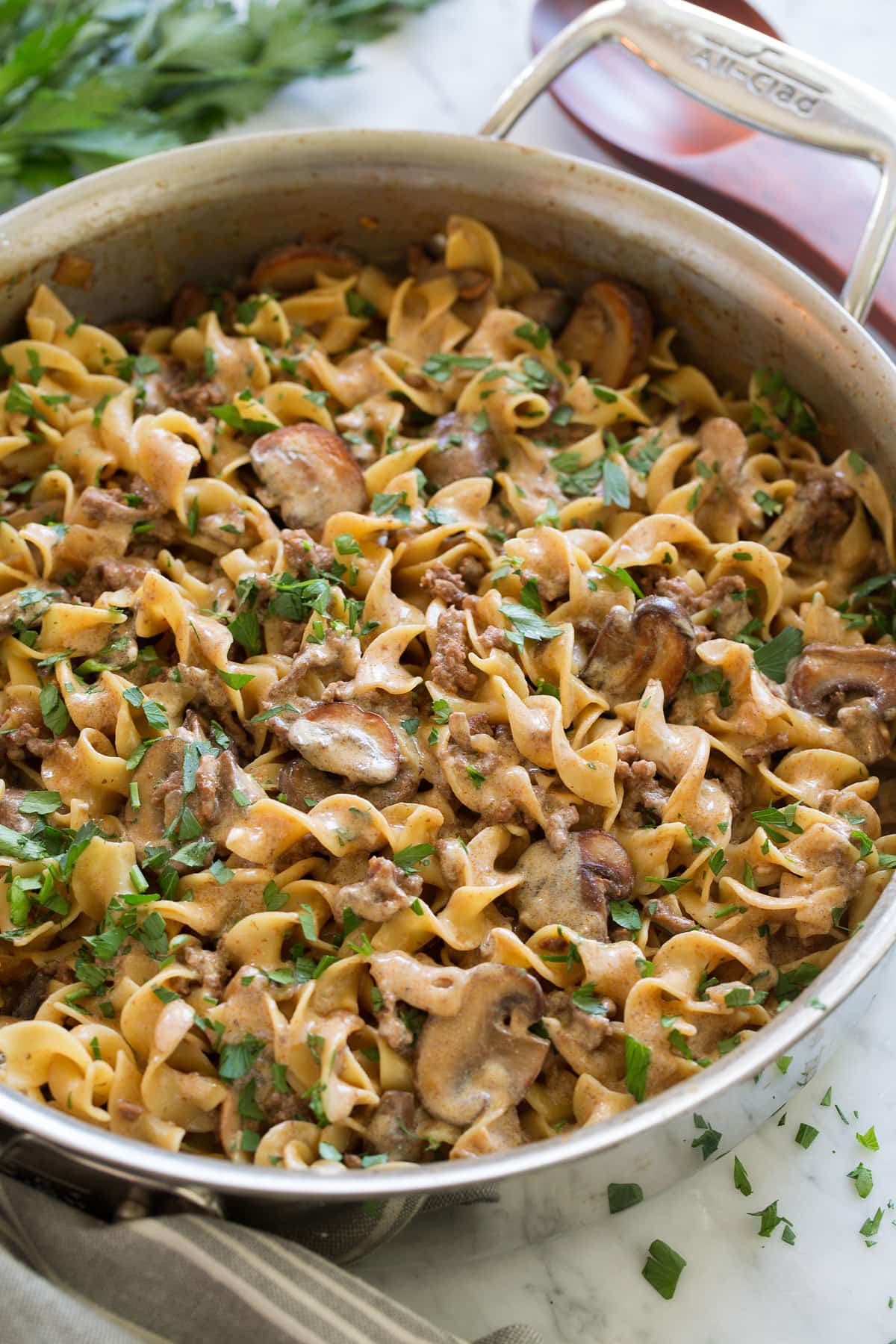 Beef Stroganoff Recipe in a large stainless steel saute pan set over a marble surface.