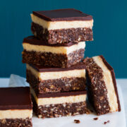 Image of four stacked Nanaimo bars with two resting on the side.