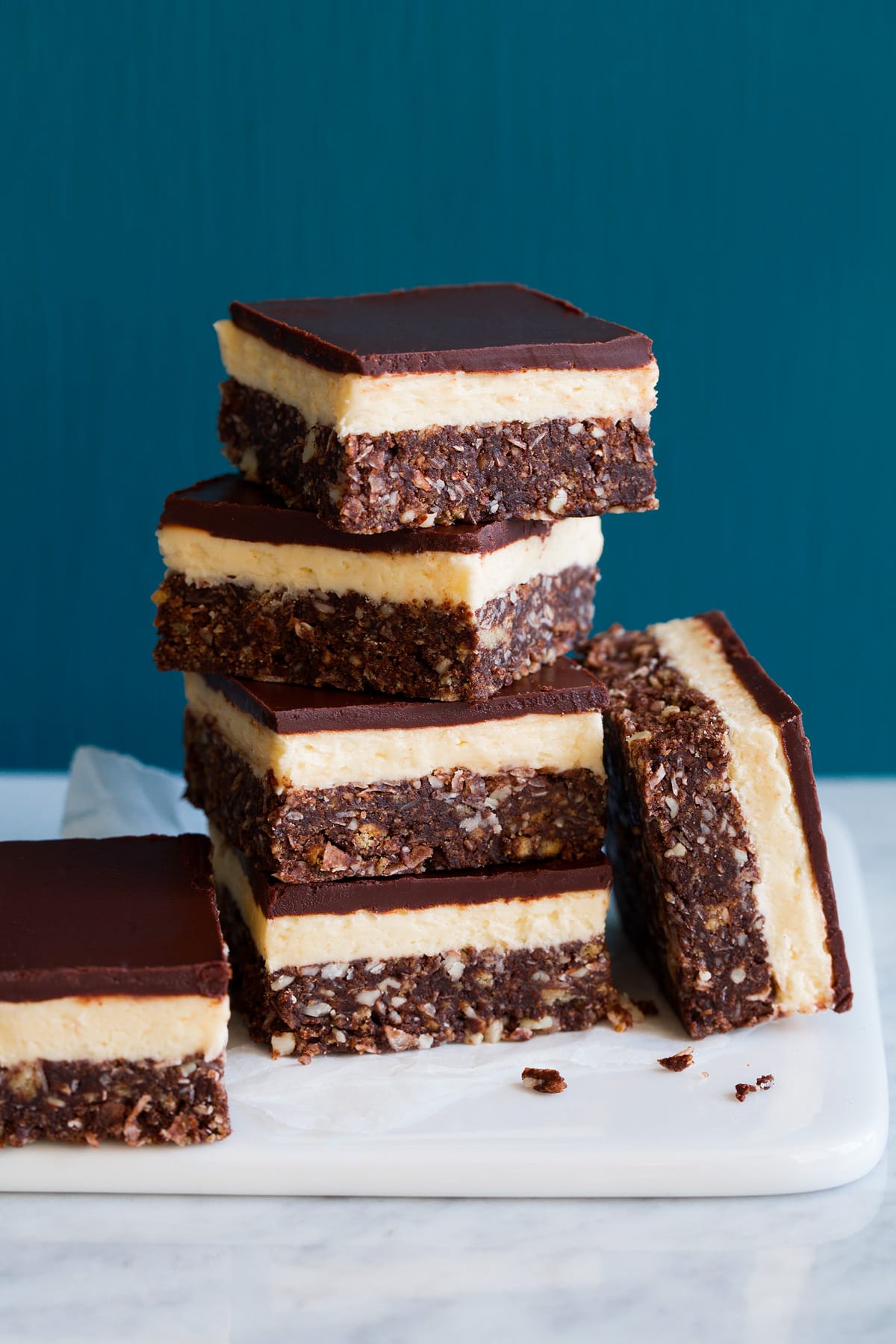 Image of four stacked Nanaimo bars with two resting on the side.