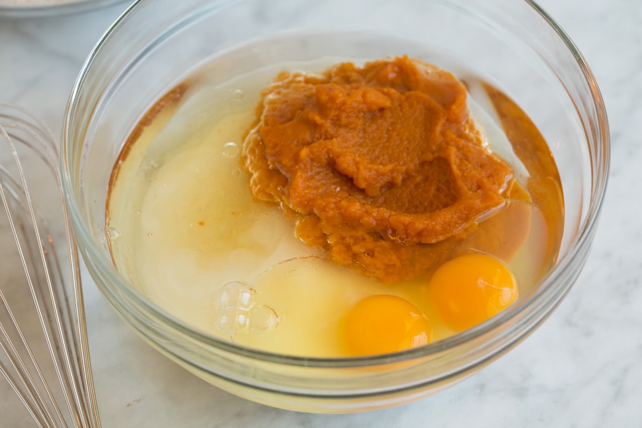 Pumpkin Muffins shown here mixing wet ingredients for batter in mixing bowl