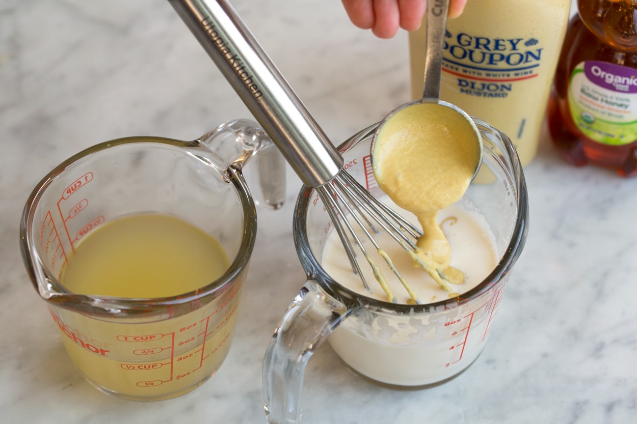 Mixing dijon into cream in measuring cup to make sauce for Salmon.