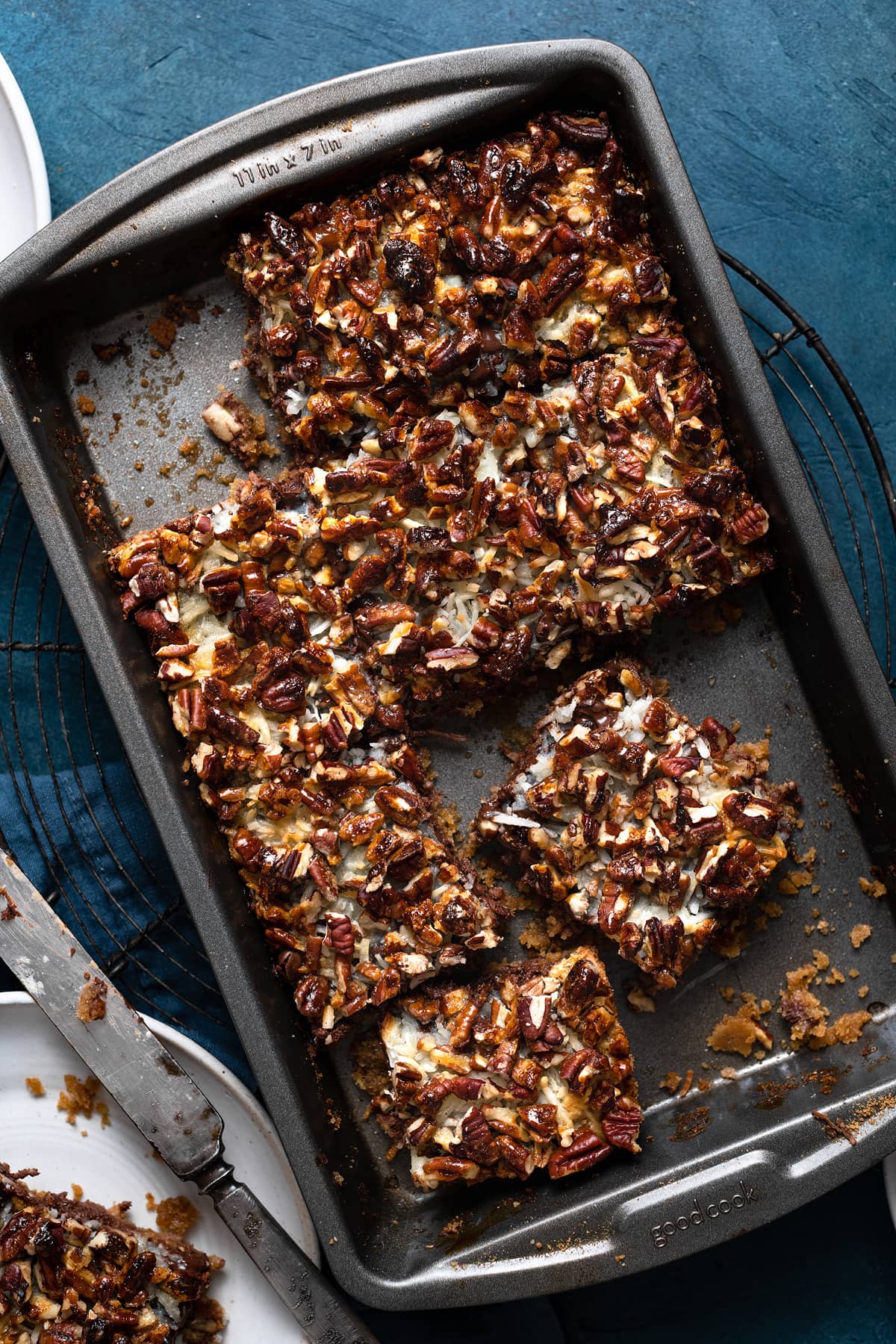 Finished seven layer magic cookie bars after baking cut into squares in baking dish.