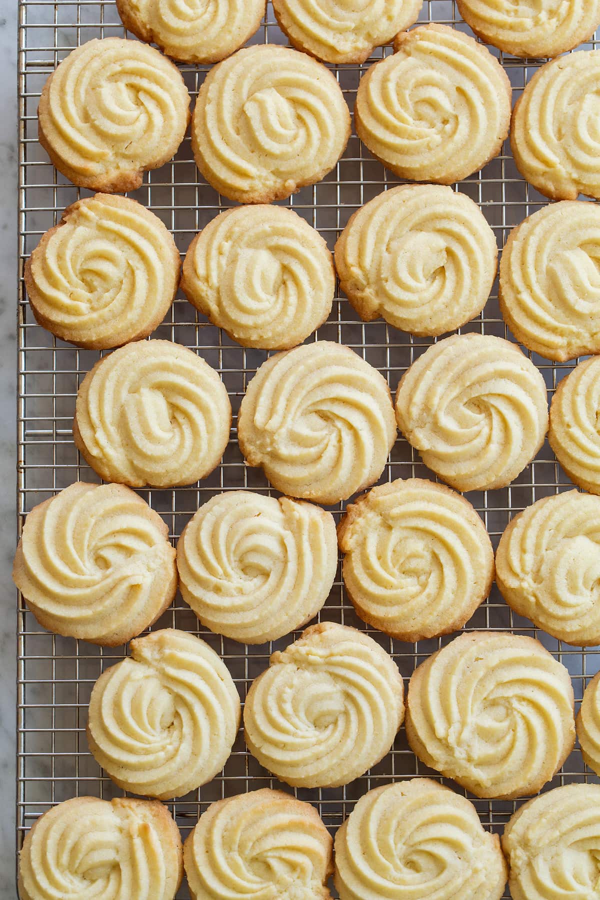 Butter cookies on a cooling rack.