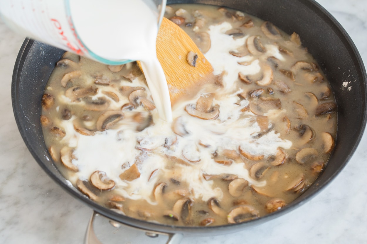 Mixing half and half and chicken broth into mushroom mixture for Green Bean Casserole.