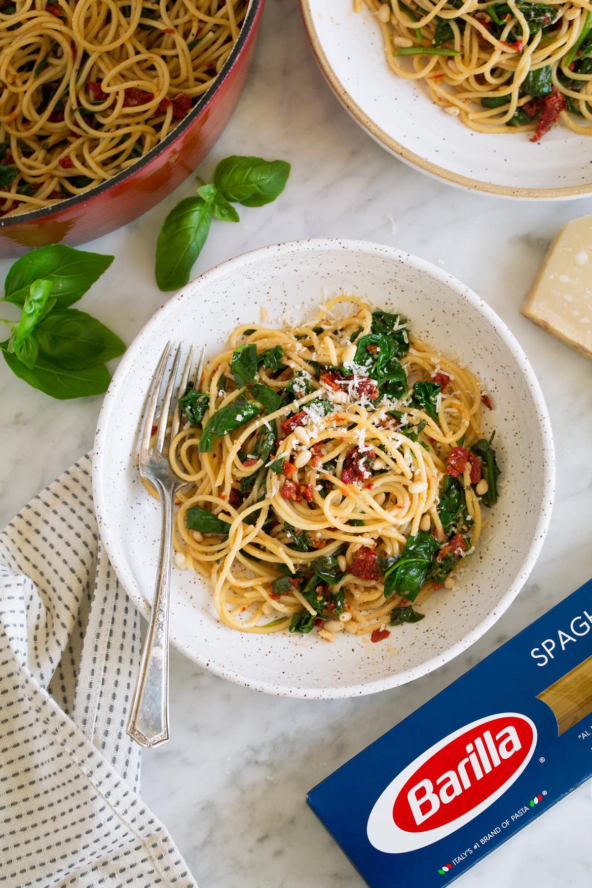 bowl of sun dried tomato pasta next to box of barilla pasta