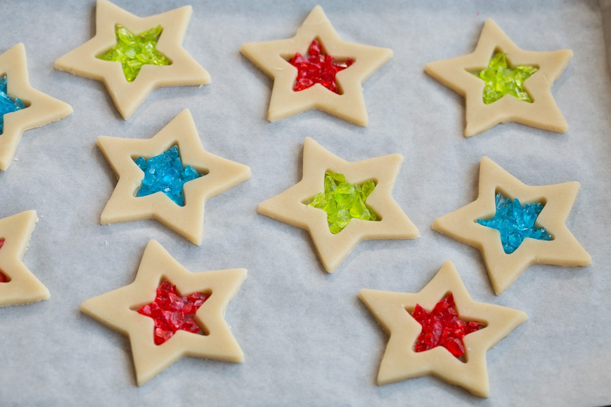 Filling center of cut out cookies with jolly ranchers for stained glass cookies. Shown before baking.