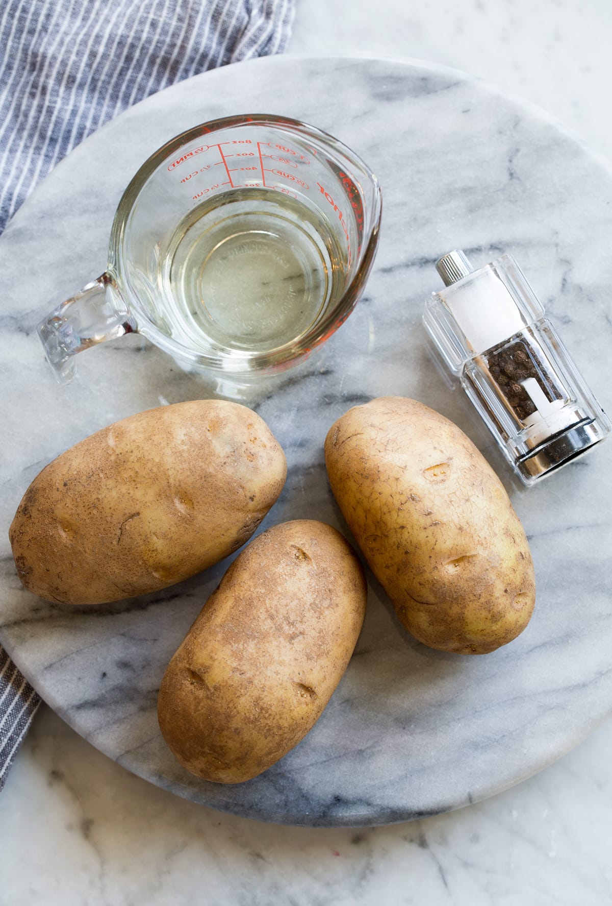 Baked French Fries French Fries Ingredients shown here including russet potatoes, vegetable oil, salt and pepper.