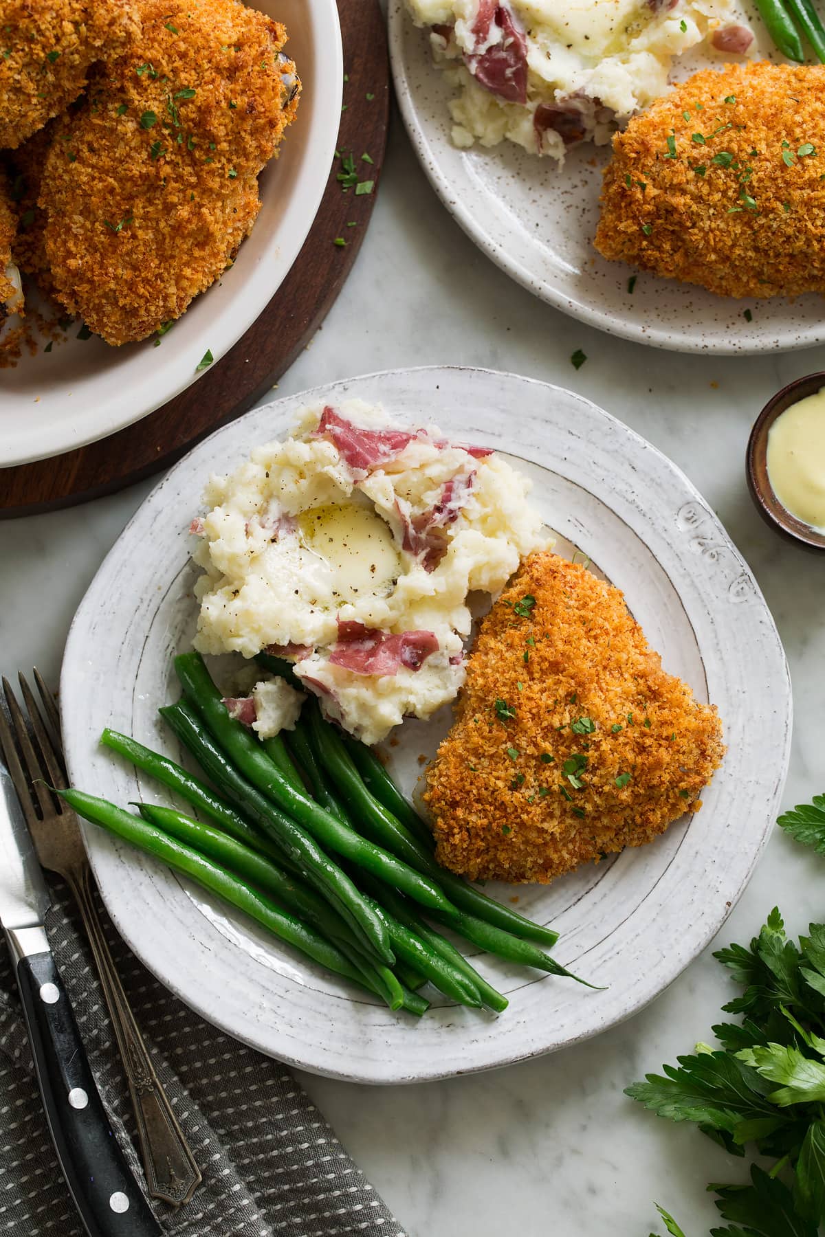 Oven Fried Chicken on white plate with mashed potatoes and green beans