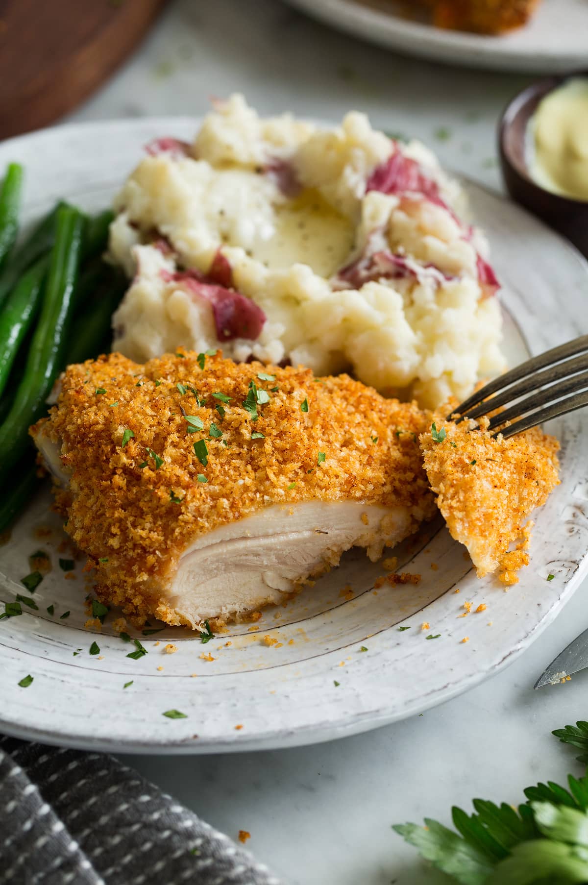 Slicing into a piece of Oven Fried Chicken