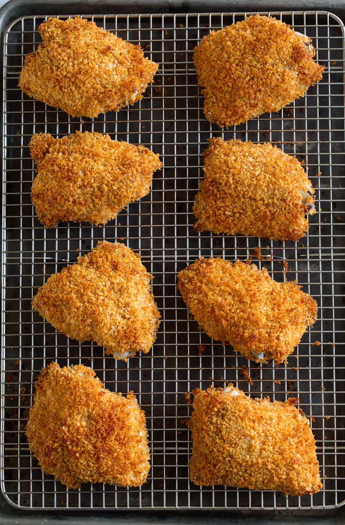 Oven Fried Chicken on a cooling rack set over a baking sheet.