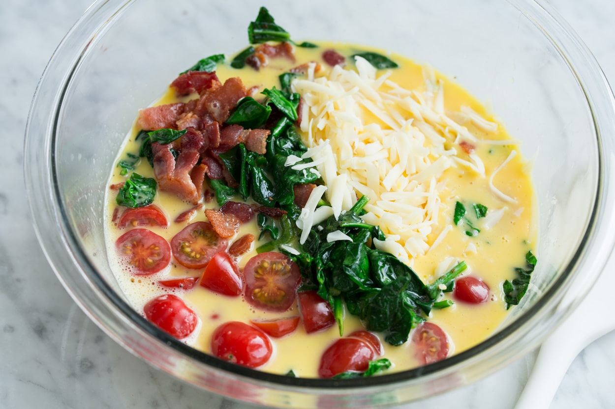 Frittata Recipe (Bacon, Spinach, Tomato and Swiss) Adding bacon, spinach, tomatoes and swiss to egg mixture for the frittata.