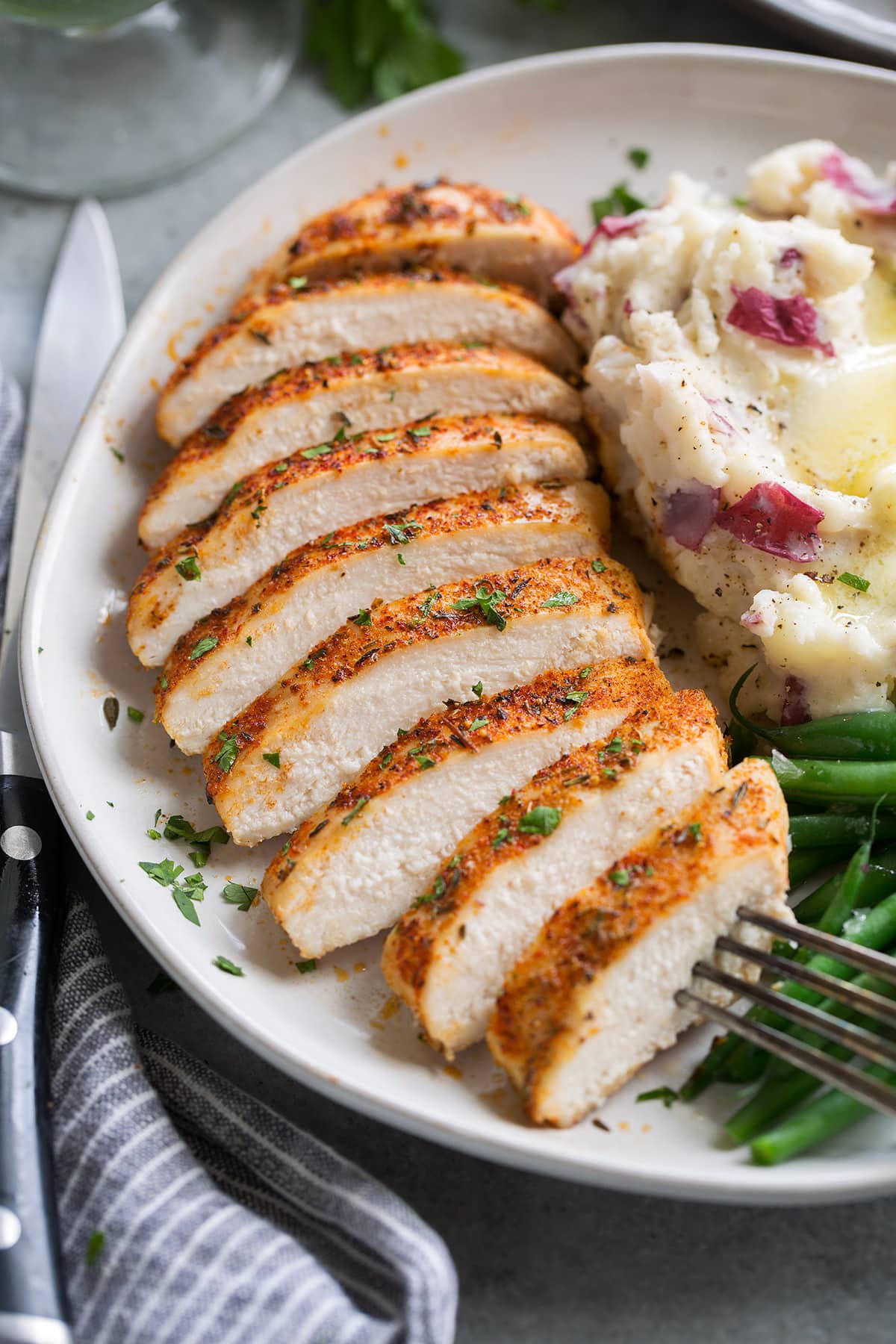 Chicken breast sliced into nine pieces, showing white, tender, moist interior.
