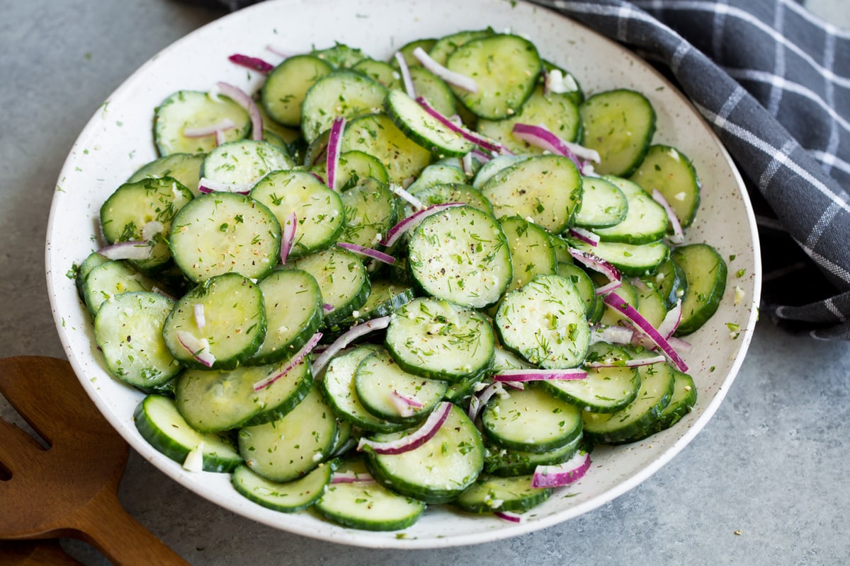 Cucumber salad in serving bowl after tossing together.