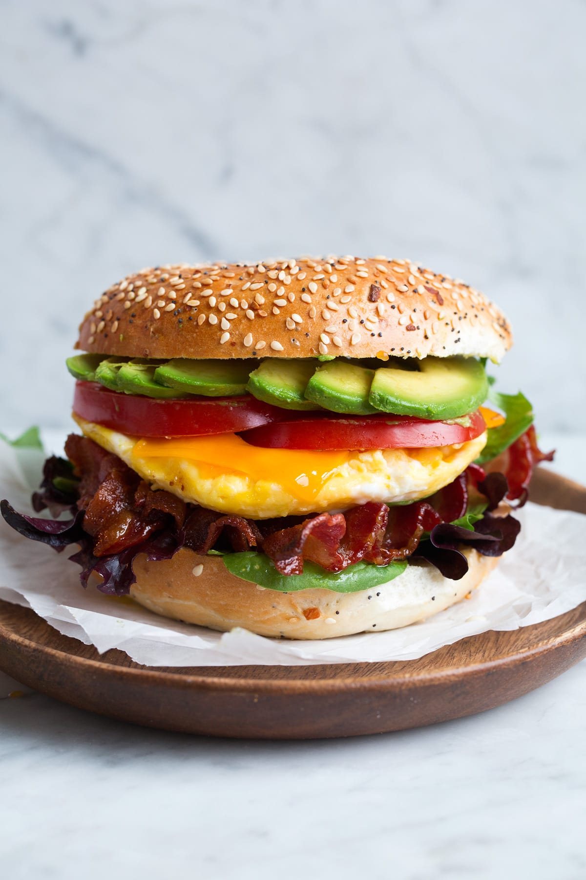 Bagel sandwich with microwave eggs, bacon, avocado, tomato, cheddar and lettuce.